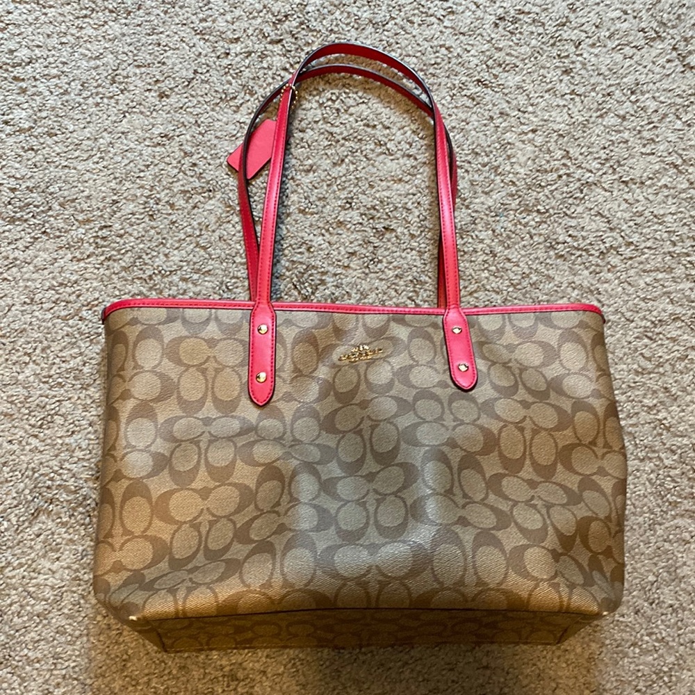 Coach shoulder bag with pink detailing.
